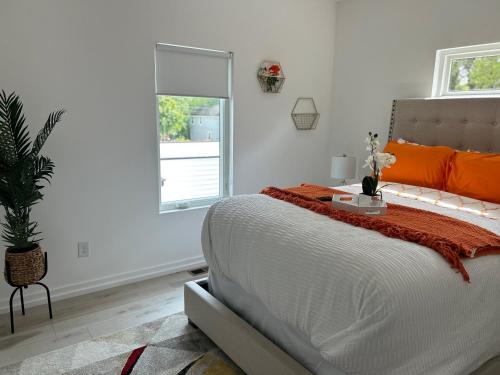a bedroom with a bed with an orange blanket on it at Atlanta Elegance in Atlanta