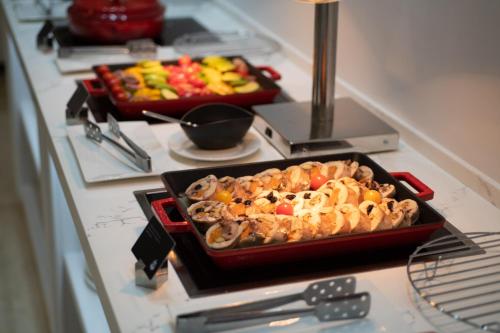 a buffet with a tray of food on a counter at LOTTE City Hotels Tashkent Palace in Tashkent