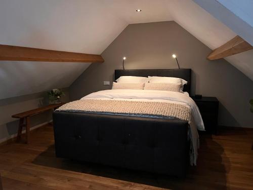 a bedroom with a large bed in a attic at Bed en wellness de Heyde in Veghel