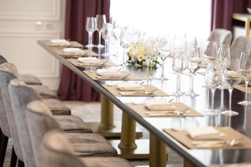 a long table with glasses and napkins on it at LOTTE City Hotels Tashkent Palace in Tashkent