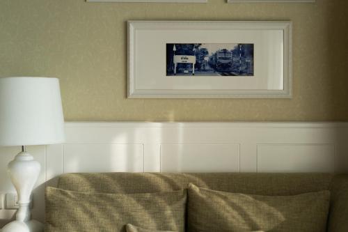 a picture above a couch in a living room at Amari Hua Hin in Hua Hin