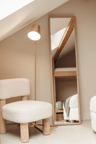 a room with a chair and a mirror at le chalet de Plainpalais in Les Déserts