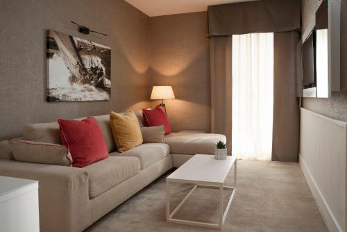 a living room with a couch and a table at Hotel Maestrale in Riccione