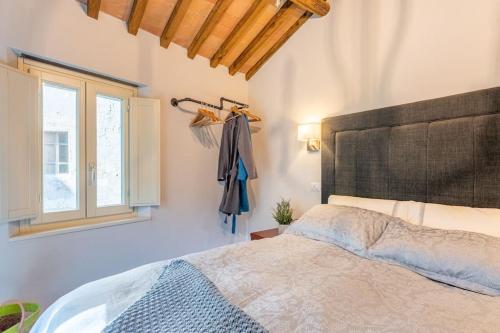a bedroom with a bed and a window at The Liberties - Luxury Villa in Barga Old Town in Barga