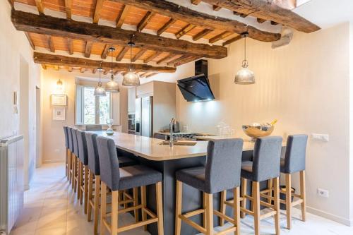 a kitchen with a large wooden table and chairs at The Liberties - Luxury Villa in Barga Old Town in Barga