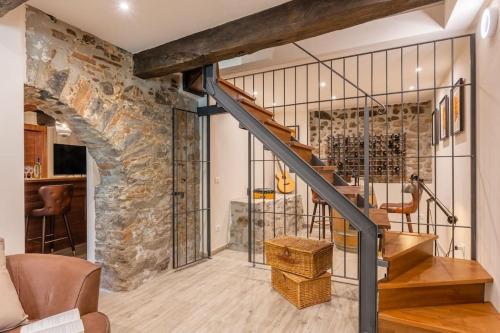 a staircase in a house with a stone wall at The Liberties - Luxury Villa in Barga Old Town in Barga
