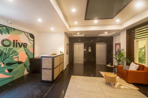 a living room with a couch and a table at Olive Hotel Electronic City by Embassy Group in Bengaluru