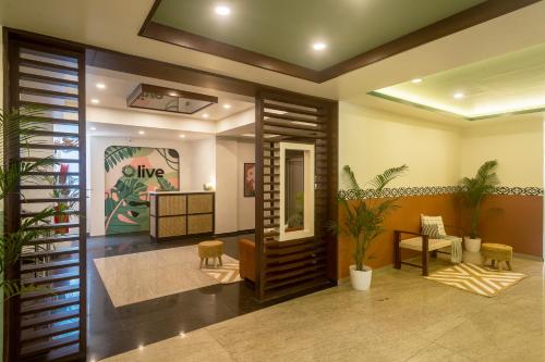 a lobby with a waiting room with plants at Olive Hotel Electronic City by Embassy Group in Bengaluru