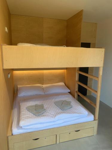 a bunk bed with two hats on top of it at Apartmány na Plešivci in Abertamy