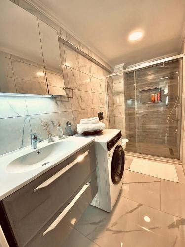 a bathroom with a sink and a washing machine at Port Mansion in Marmaris