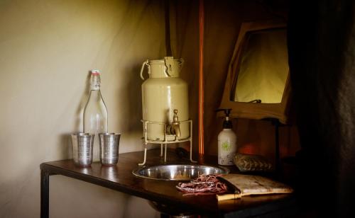 a kitchen counter with a bottle and a sink at Esirai Camp in Sinoni