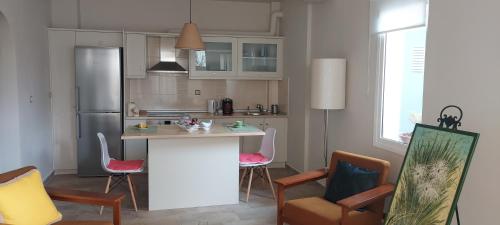 a kitchen with a island in the middle of a room at Aqua in Artemida