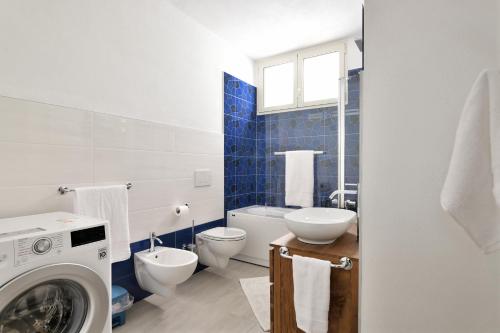 a bathroom with a washing machine and a toilet at Villa Isabel in Cala Gonone