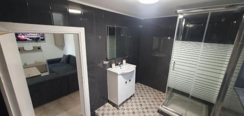 a bathroom with a toilet and a sink and a shower at TSAGGA HOUSE in Oropós