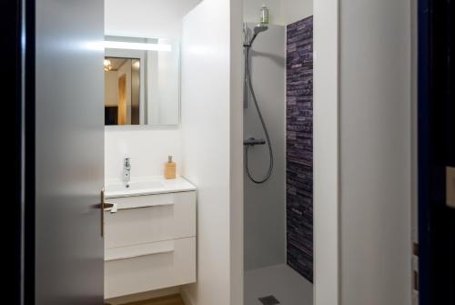 a white bathroom with a sink and a shower at 8 min de la plage, 2 de la gare, 15 de St-Nazaire in La Baule