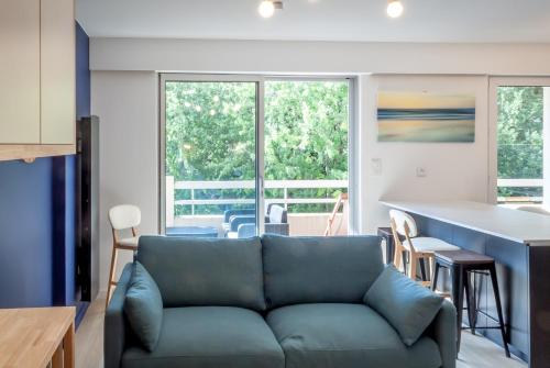 un salon avec un canapé et une cuisine dans l'établissement 8 min de la plage, 2 de la gare, 15 de St-Nazaire, à La Baule