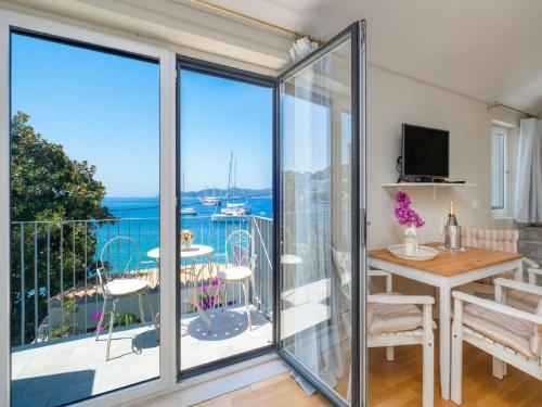 a room with a balcony with a view of the ocean at Villa Lola in Lopud