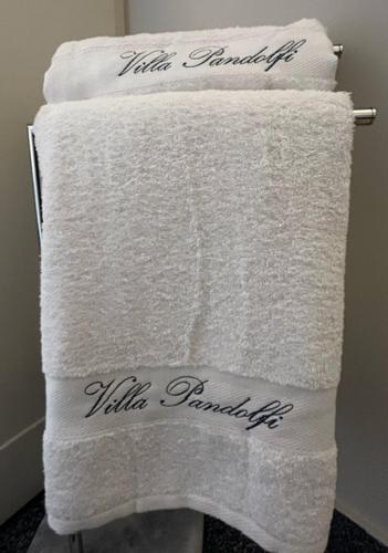 a pile of white towels on a rack in a bathroom at Villa Pandolfi in Pescara