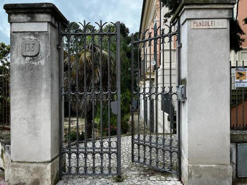 a gate to a building with a stone pillar at Villa Pandolfi in Pescara