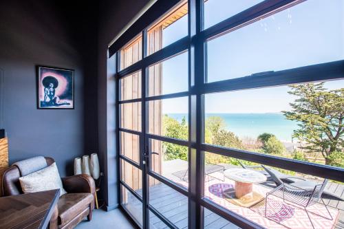 a room with a view of the ocean through a window at Chy conary in Carbis Bay