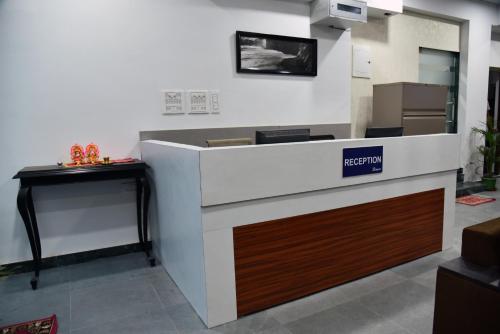 a cashier counter in a store with a box at The Altruist Business Stays- New Town, Kolkata in Kolkata