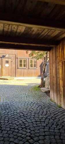 a pavilion with a brick walkway in front of a building at Vertshuset Røros in Røros