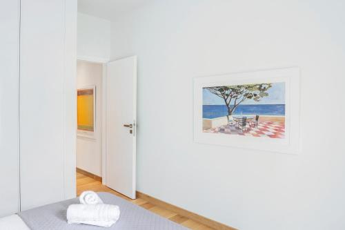 a room with white walls and a painting on the wall at Luxury 1BR Flat in the Heart of Athens in Athens