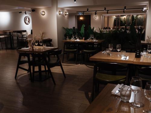 a restaurant with wooden tables and chairs in a room at Auberge du Lyonnais in Annecy