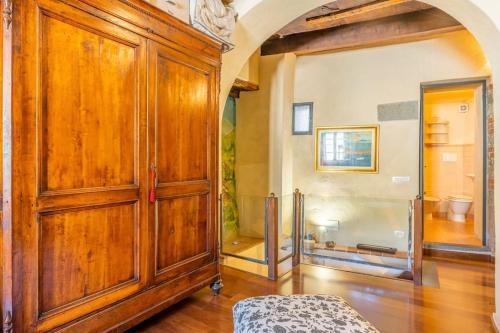 a large room with a large wooden cabinet at Villa Camelia Bianca in Barga