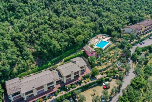 an aerial view of a house with a swimming pool at Flat in Garden Residence resort, Malcesine, Italy (with heated pool) in Malcesine