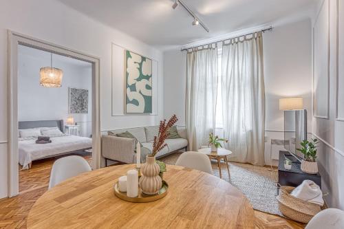 a living room with a table and a bedroom at Spacious Apartment In Heart Of Zagreb - Happy Rentals in Zagreb