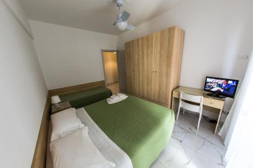 Ένα ή περισσότερα κρεβάτια σε δωμάτιο στο Ligure Residence Appartamenti per Vacanze