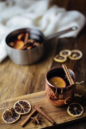 a wooden table with a cup of coffee and spices at Auberge du Lyonnais in Annecy