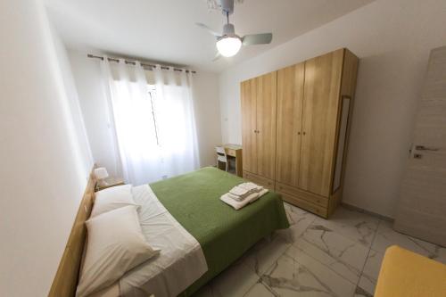 Ένα ή περισσότερα κρεβάτια σε δωμάτιο στο Ligure Residence Appartamenti per Vacanze