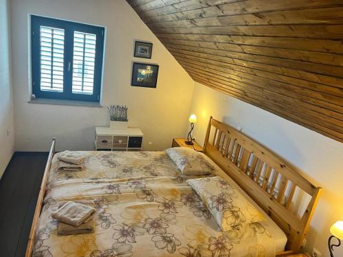 a bedroom with a large bed with a wooden headboard at Villa Monica in Ložišće