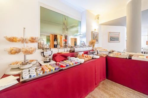 a buffet line with various food items on display at Hotel Villa Luisa in Lignano Sabbiadoro