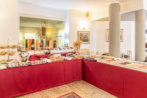 a buffet line with many different types of food at Hotel Villa Luisa in Lignano Sabbiadoro