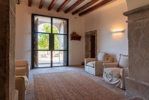 a living room with a couch and a large window at Agroturisme Subies in Selva