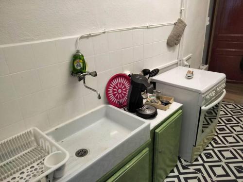 a kitchen with a sink and a stove at Le nid douillet Vintage idéal pour 2 jusqu'à 4 in La Bourboule