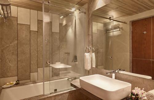 a bathroom with a sink and a tub and a shower at Click Hotel Aurangabad in Aurangabad