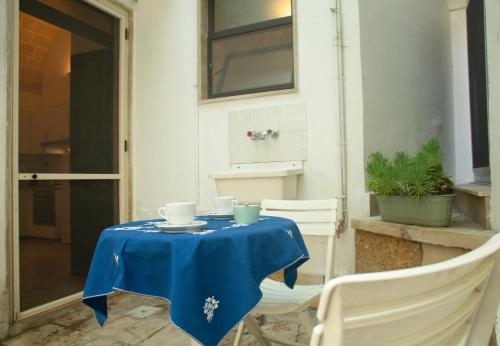 a table with a blue table cloth on it at Casetta Diana - The Fab Stay in Brindisi