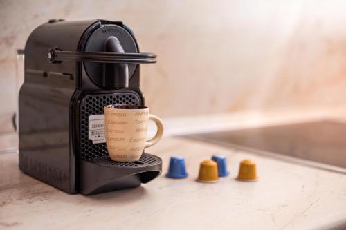 a coffee maker with a cup on a counter at Christina's House in Afantou