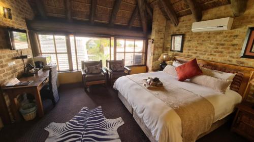 a bedroom with a bed with a dog sitting on it at Klein Bosveld Guest House in Witbank