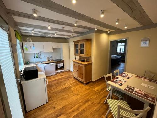 a kitchen and living room with a table and a counter at Gasthaus Zum Goldenen Hirsch in Schriesheim