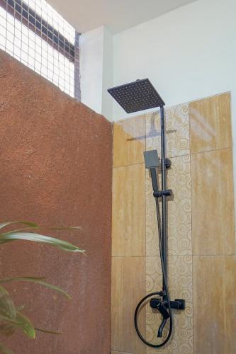 a shower with a solar light in a bathroom at Casa de Saka Villa in Ngaglik