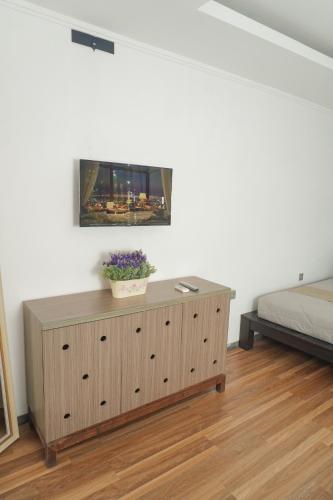 a bedroom with a television on top of a dresser at Casa de Saka Villa in Ngaglik