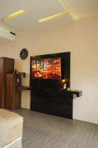 a living room with a flat screen tv on a wall at Casa de Saka Villa in Ngaglik