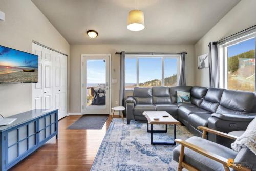 a living room with a couch and a table at The Mountain Top Escape w/Scenic Views & Trails in Anchorage