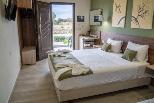 um quarto com uma cama grande e uma janela em Lafo Rooms em Elafonisi