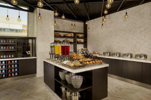 a kitchen with a counter with a bunch of food at Aloft Birmingham Eastside in Birmingham